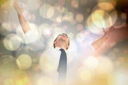 Handsome businessman cheering with arms up against light glowing dots design patternの写真素材