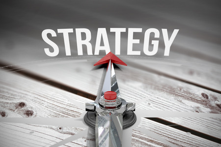 The word strategy and compass against digitally generated grey wooden planks