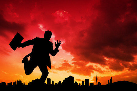 Businessman silhouette against cityscape designの写真素材