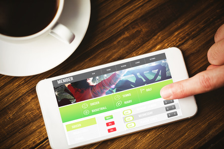 Gambling app screen against hand using smartphoneの写真素材