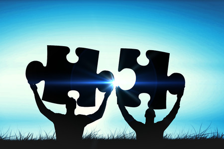 happy cheering businessman raising his arms against blue sky over grassの写真素材