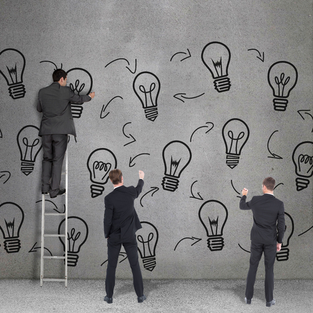 Business team writing against grey roomの写真素材