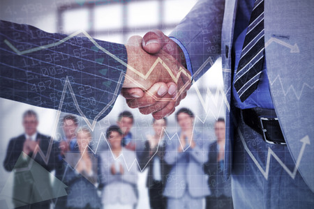 businessman shaking hands with a co worker against stocks and shares
