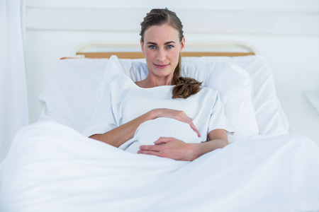 Confident pregnant woman looking at cameraの写真素材