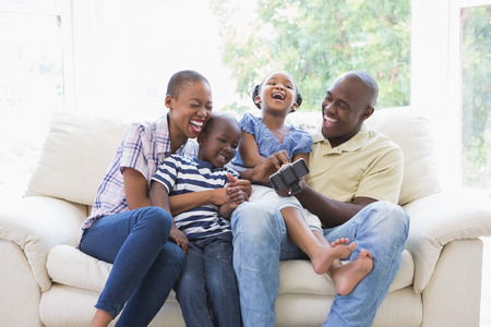 Happy smiling family on the couch in the living room