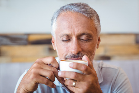 Man sitting in cafe having coffee in a cafeの写真素材