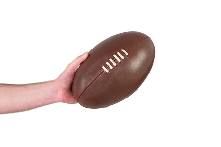 Rugby player handing a rugby ball on a white backgroundの写真素材