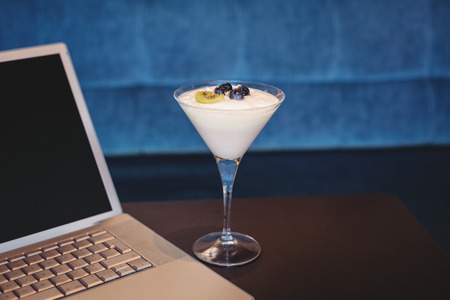 close up view of a laptop and a parfait at the cafeの写真素材