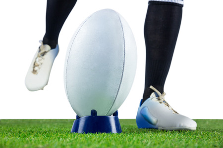 Low angle view of a rugby player doing a drop kickの写真素材