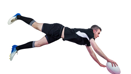 A determined rugby player scoring a tryの写真素材