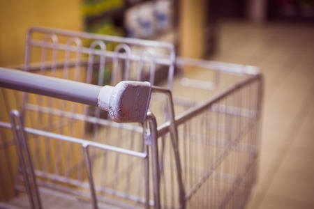 Trolley with product on shelf in supermarketの写真素材
