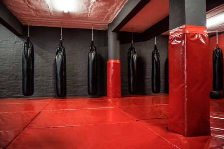 Red boxing area  with punching bags in crossfit gymの写真素材