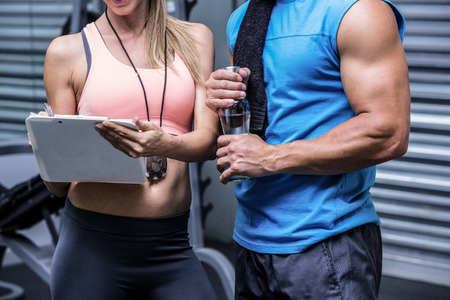 Young woman smiling with a young man in the crossfit gymの写真素材