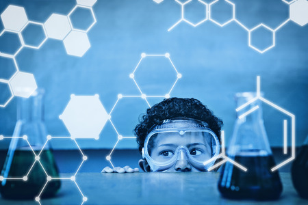 Science graphic against boy looking at conical flasks in classroomの写真素材