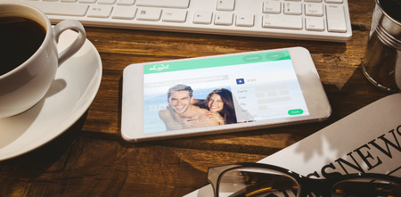 Dating website against smartphone on deskの写真素材