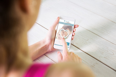 Woman using her smartphone against dating websiteの写真素材