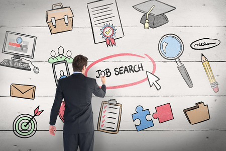 Businessman standing back to camera writing with marker against white woodの写真素材