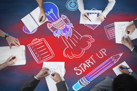 Business meeting against blue chalkboardの写真素材