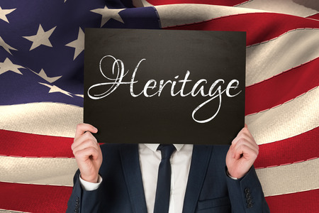 Businessman holding board against heritageの写真素材