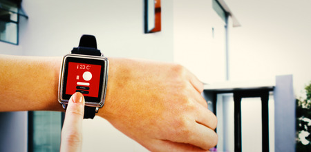 Smartwatch on wrist against home control centreの写真素材