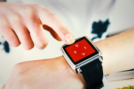Woman using smartwatch against home control systemの写真素材