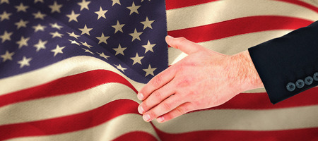 Hand of businessman offering handshake against beige