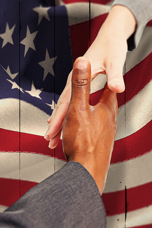 Businesspeople going to shake hands against white woodの写真素材