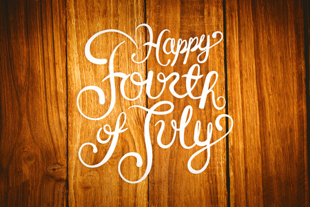 Independence day graphic against wooden tableの写真素材