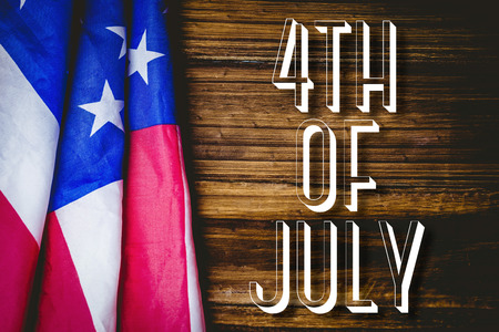 Independence day graphic against usa flag on tableの写真素材