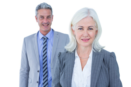 businessman and businesswoman smiling at the camera on white backgroundの写真素材
