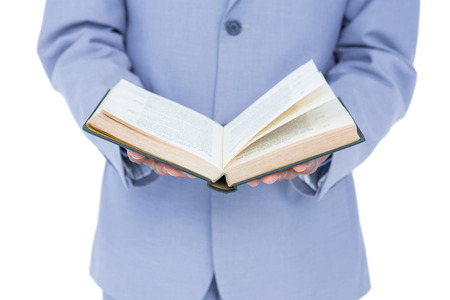 businessman holding a book on white background