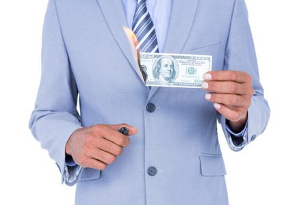 businessman burning a dollar banknote on white backgroundの写真素材
