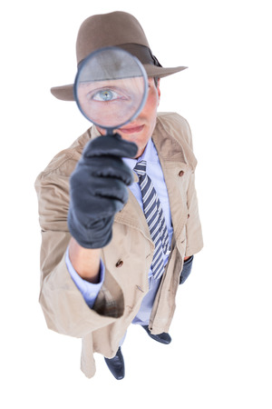 Spy looking through magnifier on white backgroundの写真素材