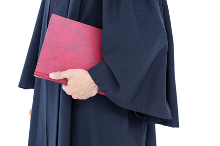 Happy handsome lawyer holding labor code on white backgroundの写真素材