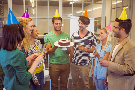 Portrait of creative business people celebrating a birthday