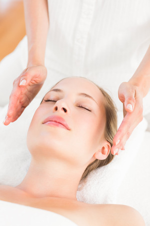 Calm woman receiving reiki treatment in the health spaの写真素材