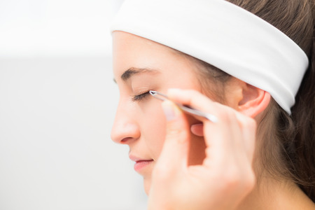 Close up of a hand applying eyeshadow to beautiful woman