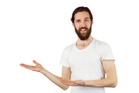 Handsome hipster presenting a copy space on white backgroundの写真素材