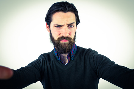 Handsome hipster taking a selfie on vignette background