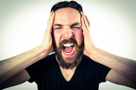 Handsome hipster shouting at camera on vignette background