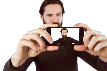 Handsome hipster taking a selfie on white backgroundの写真素材