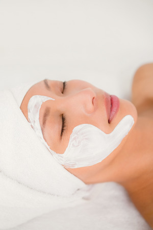 Close up view of an attractive woman with cream treatment at spa centerの写真素材