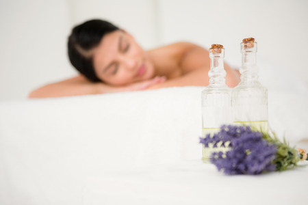 Focus on two massage oil bottles and lavenderの写真素材