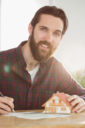 Hipster businessman applying for a mortgage in his officeの写真素材