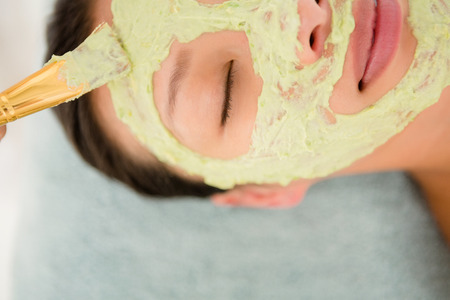 Close-up of an attractive young woman receiving treatment at spa centerの写真素材