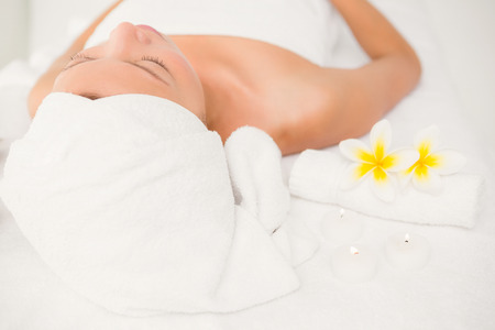 Relaxed woman lying on the massage table at the health spaの写真素材