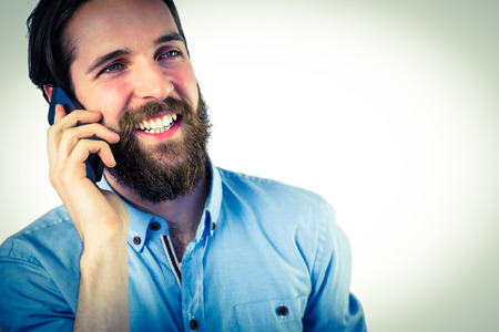 Handsome hipster making a call on vignette backgroundの写真素材