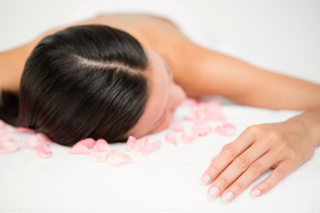 Relaxed woman lying on the massage table at the health spaの写真素材