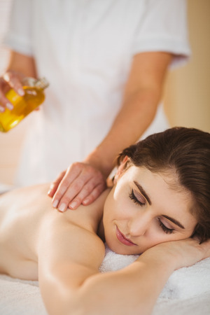 Young woman getting a massage in therapy roomの写真素材