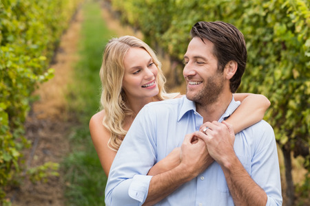 Young happy couple embracing each other in the grape fieldsの写真素材